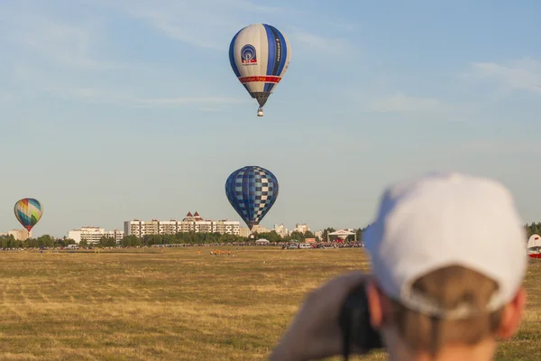 Man Watching At  Air-Balloons Participating in International Aerostatics Cup Called 70 Years of Peaceful Sky