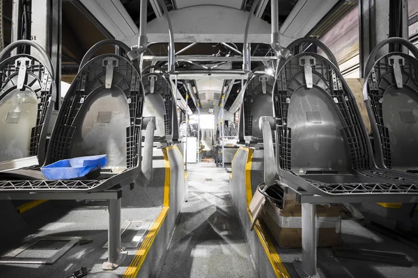 Amodern bus interior, disassembled, during reconstruction