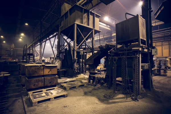 A steel manufacturing plant, interior, poor light
