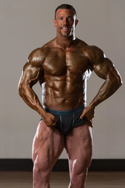 Muscular Man Flexing Muscles