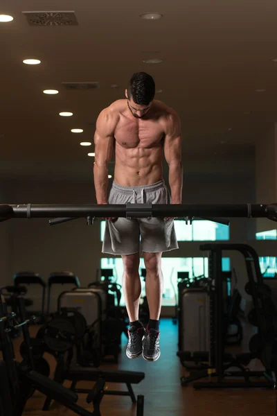 Young Bodybuilder Exercising Triceps Doing Dips on Bar