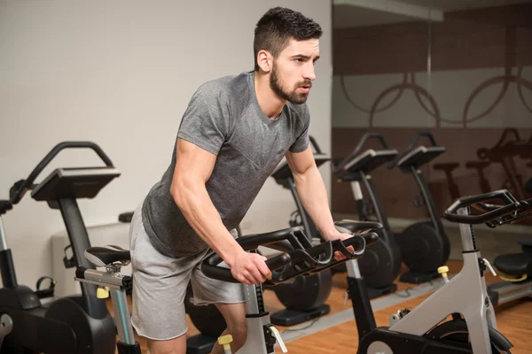 Young Man Cycling On Bike Bodybuilding Trainer