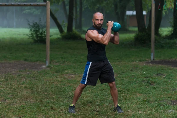 Handsome Muscular Man Holding Kettle Bell