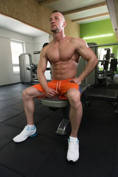 Attractive Young Man Resting In Gym Afther Exercise