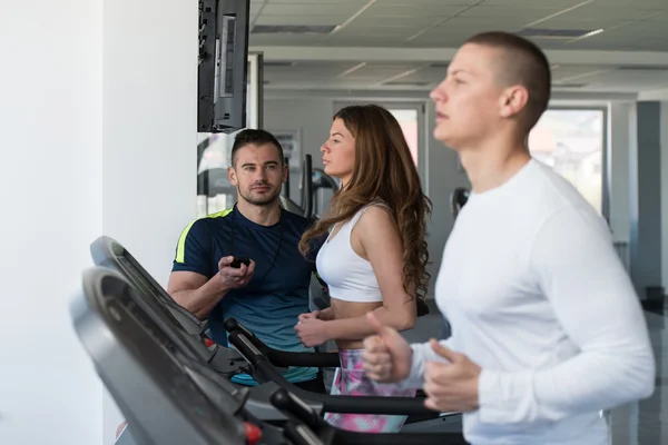 Group Of People Running On Treadmills In Gym