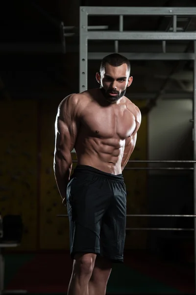 Handsome Bodybuilder Making Side Triceps Pose