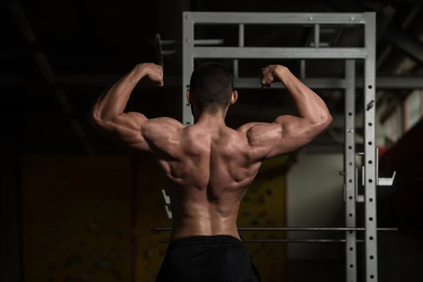 Young Bodybuilder Flexing Rear Double Biceps Pose