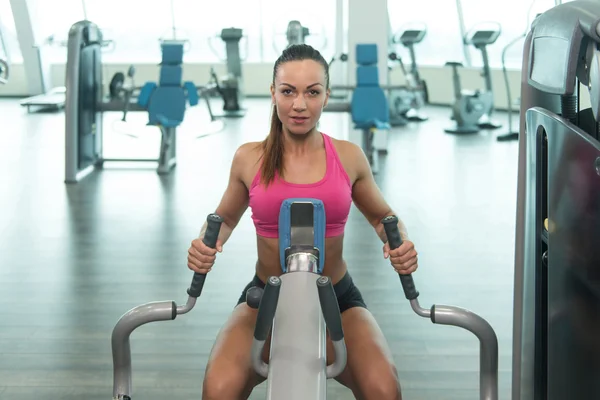 Fitness Woman Doing Exercise For Back On Machine