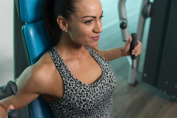 Healthy Young Woman Exercise Chest On Machine