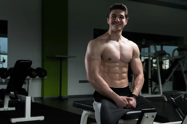 Attractive Young Man Resting In Gym Afther Exercise