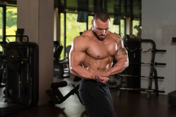 Athlete Muscular Bodybuilder Posing In The Gym