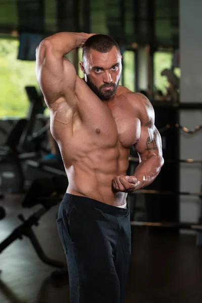 Athlete Muscular Bodybuilder Posing In The Gym