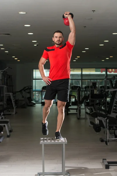 Fitness Instructor Doing Heavy Weight Exercise With Kettle-bell