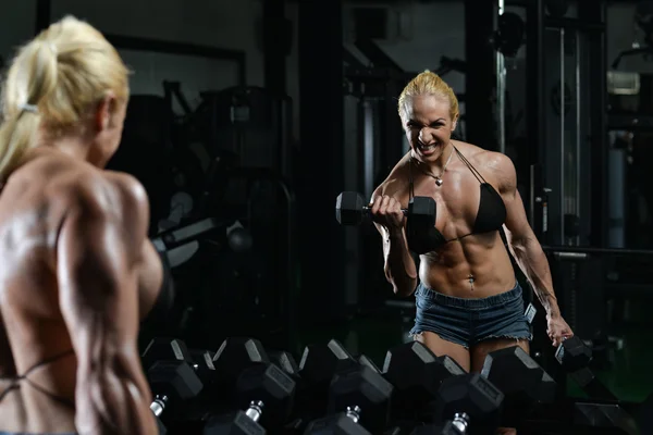 Muscular Woman Doing Heavy Weight Exercise For Biceps