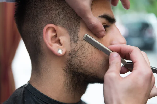 Hairdresser Shaving Man\'s Chin With A Straight Razor