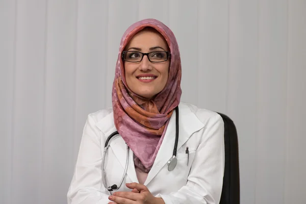 Muslim Doctor Relaxing On Office Chair