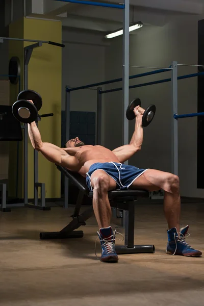 Male Athlete Doing Heavy Weight Exercise For Chest