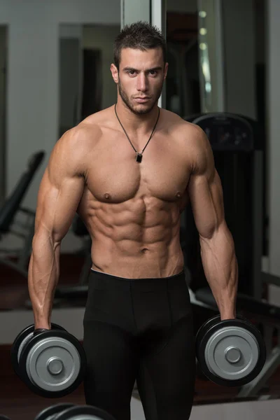 Healthy Young Man Doing Exercise For Biceps