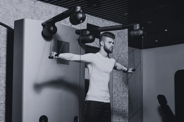 Male Athlete Doing Heavy Weight Exercise For Shoulders