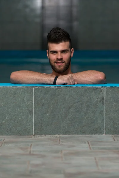 Male Swimmer Resting In Pool