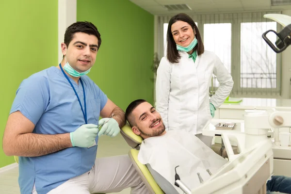 Portrait Of A Dentist , Assistant And Patient