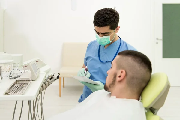 Dentist Writes On The Card Patient Personal Information