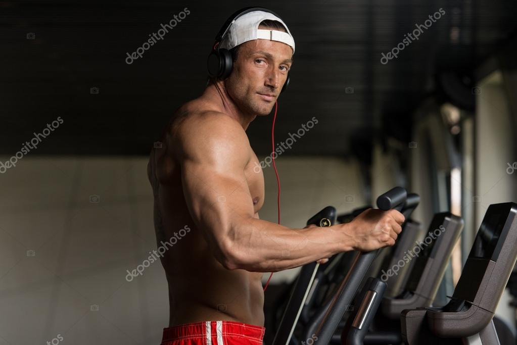Mature Man Doing Aerobics Elliptical Walker In Gym Stock Photo By Ibrak
