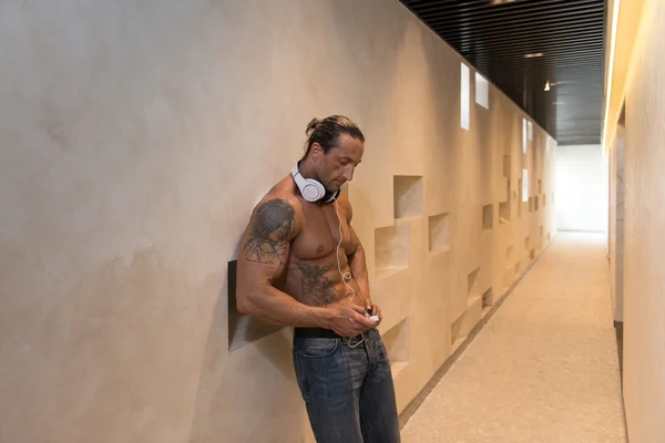 Aesthetic Man Listening Music In Modern Corridor