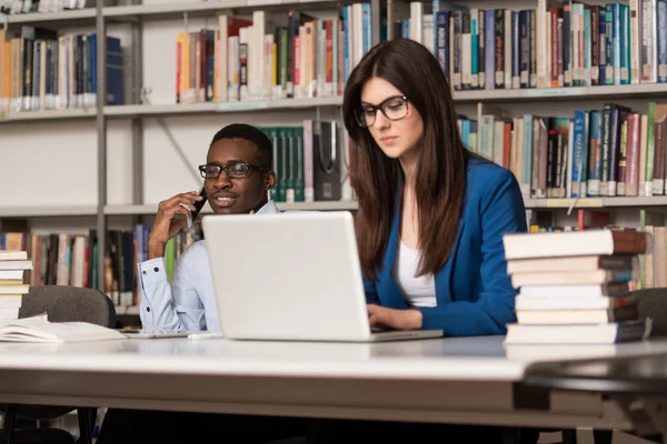 Happy Students Working With Laptop In Library