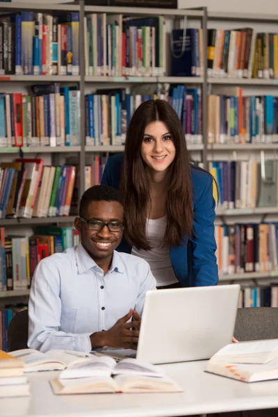 Couple Of Students With Laptop In Library