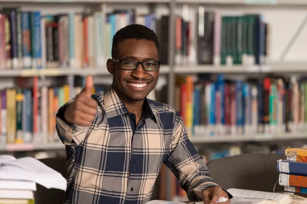 African Man In A Library Showing Thumbs Up