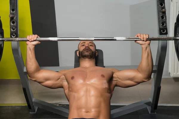 Muscular Man Doing Bench Press Exercise For Chest