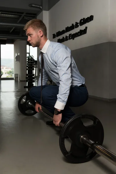 Healthy Young Businessman Doing Exercise For Back