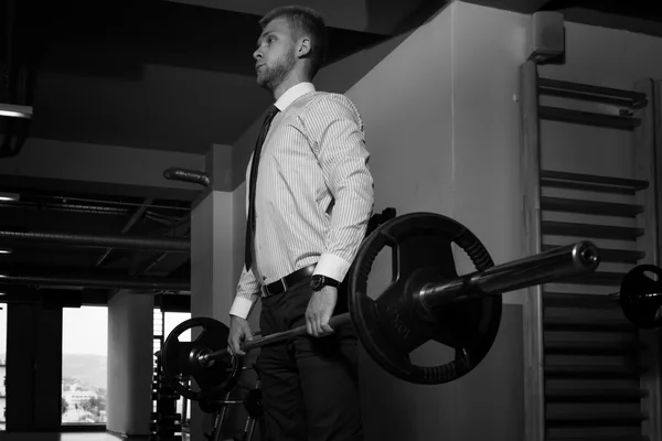 Healthy Young Businessman Doing Exercise For Back