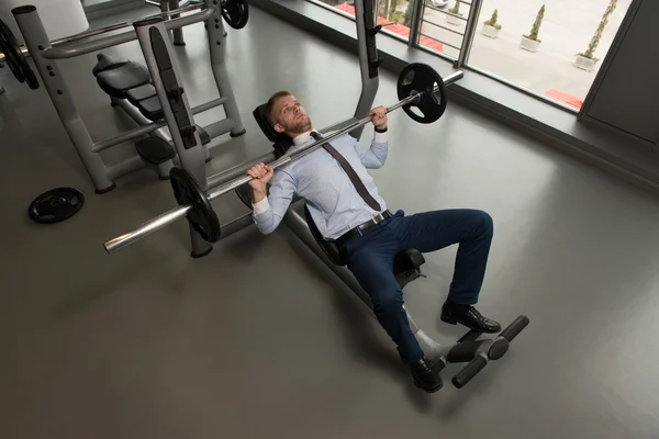 Businessman Exercise Bench Press With Barbell