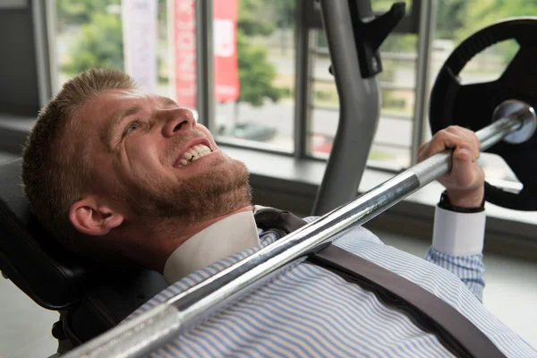 Businessman Exercise Bench Press With Barbell