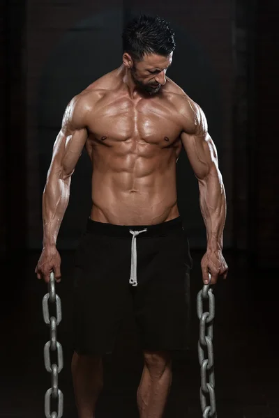 Man With Chains Showing His Well Trained Body