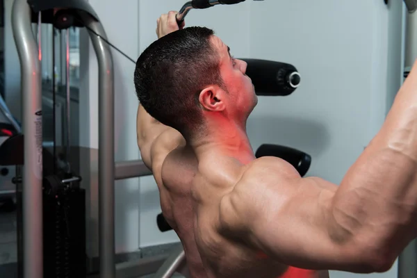 Bodybuilder Doing Heavy Weight Exercise For Back