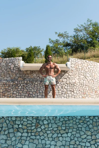 Man Flexing Muscles Outdoors In Summer Time