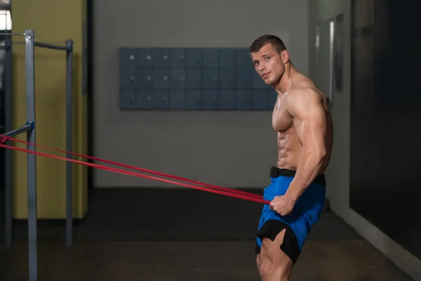 Handsome Guy Working Out With Rubber Band