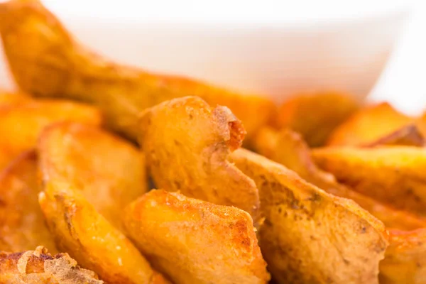 Roast potato wedges closeup.