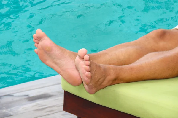 Man lying poolside