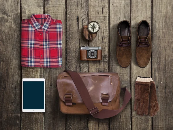 Hipster clothes and accessories on a wooden background