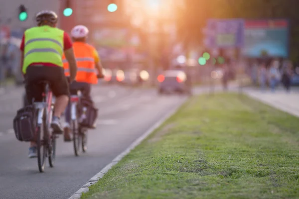 Two cyclists in a busy part of the town