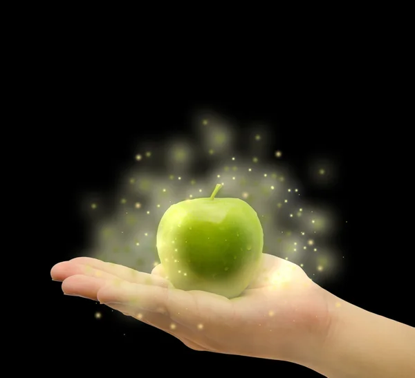 Magical apple on the palm in isolated background