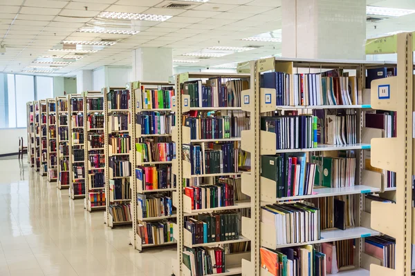 Row of bookshelves in a public library in the university, full of knowledge