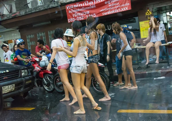 Wild chicks woman and sexy transvestite blocking cars on street in Songkran Bangkok, Thailand