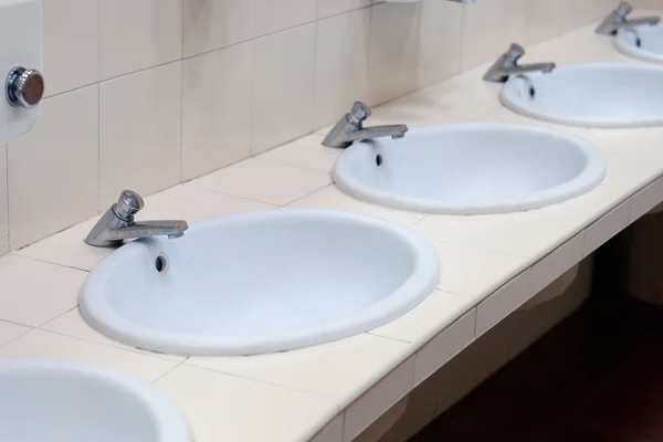 Wash basins arranged in a row