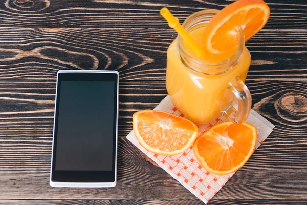 Oranges, Juice and Mobile Phone. Technology Concept