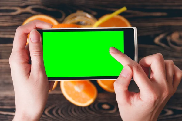 Hands Taking Photo of Oranges. Green Screen. Technology Concept